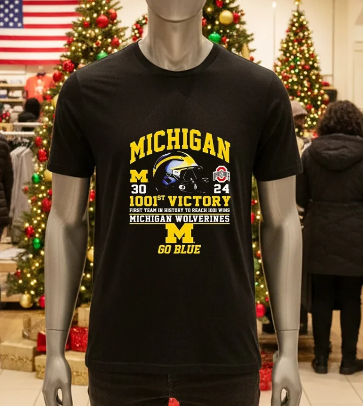 Michigan Wolverines celebrate 1001st win in "Go Blue" shirt.